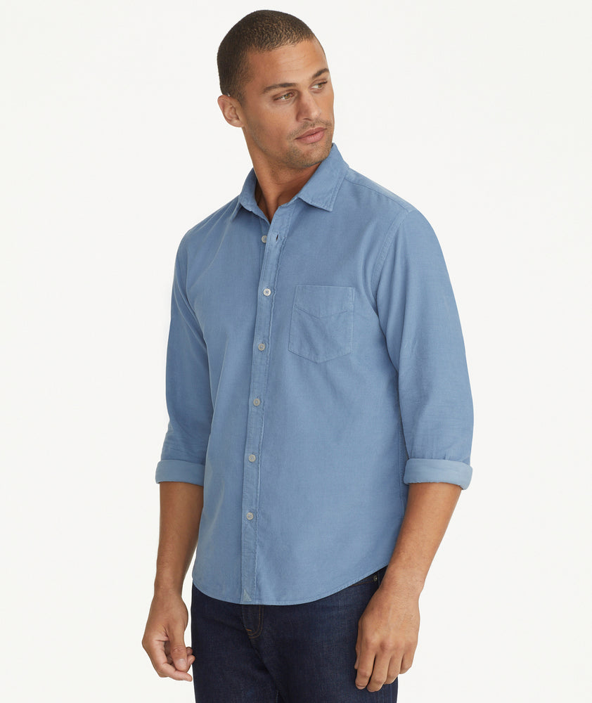 Model is wearing UNTUCKit Caprone Cord Shirt in Faded Blue.
