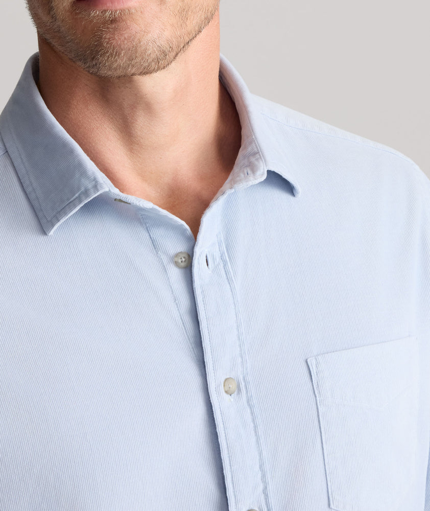 Model is wearing UNTUCKit Cord Shirt in heather blue. 