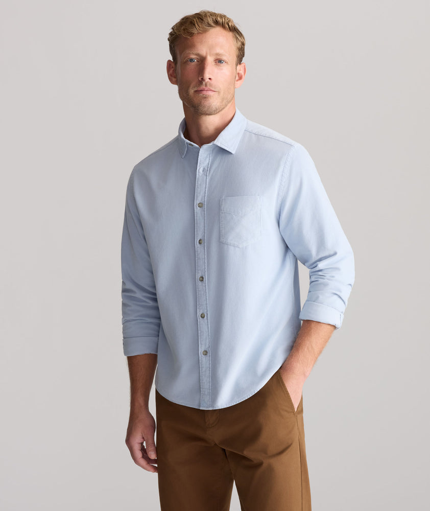 Model is wearing UNTUCKit Cord Shirt in heather blue. 