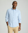 Model is wearing UNTUCKit Cord Shirt in heather blue. 