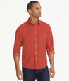 Model is wearing UNTUCKit Caprone Cord Shirt in Burnt Red.