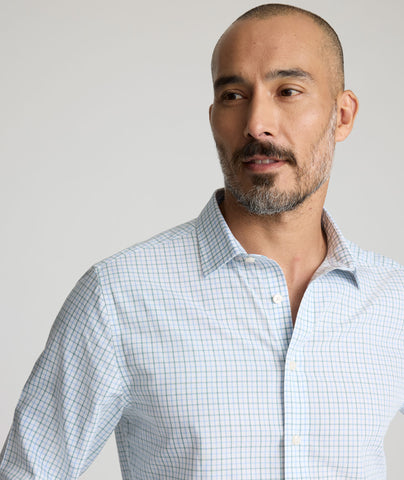 Model is wearing UNTUCKit Carillo wrinkle-free shirt in green plaid. 