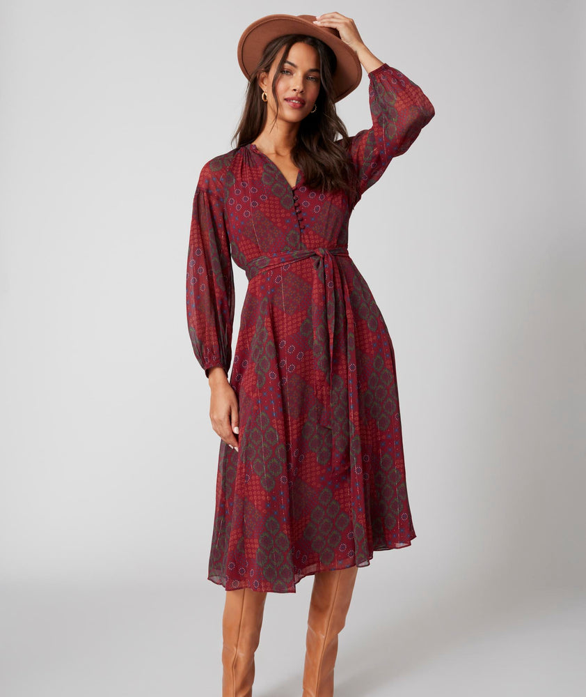 Model is wearing UNTUCKit Carly printed red dress. 