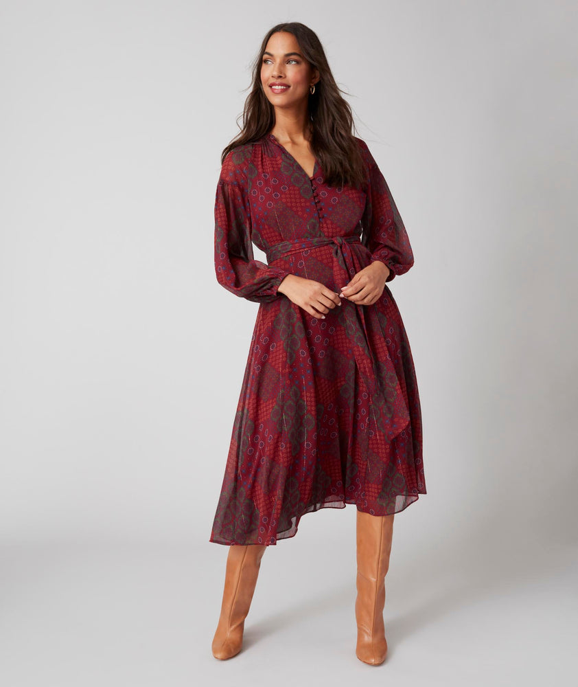 Model is wearing UNTUCKit Carly printed red dress.