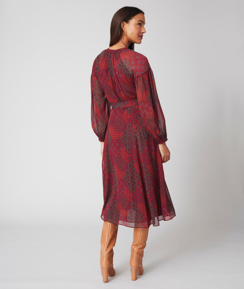 Model is wearing UNTUCKit Carly printed red dress.