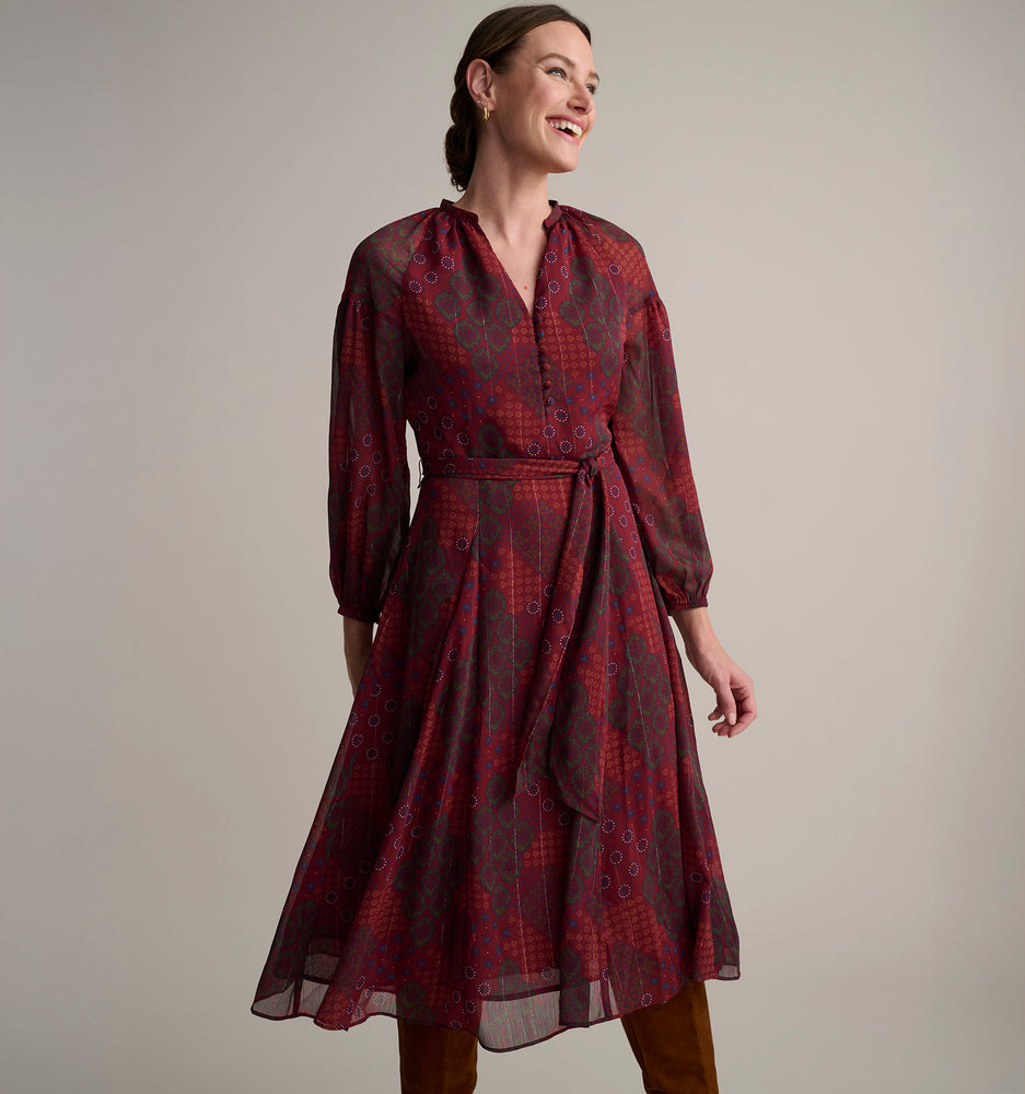 Model is wearing UNTUCKit Carly printed red dress. 