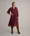 Model is wearing UNTUCKit Carly printed red dress. 