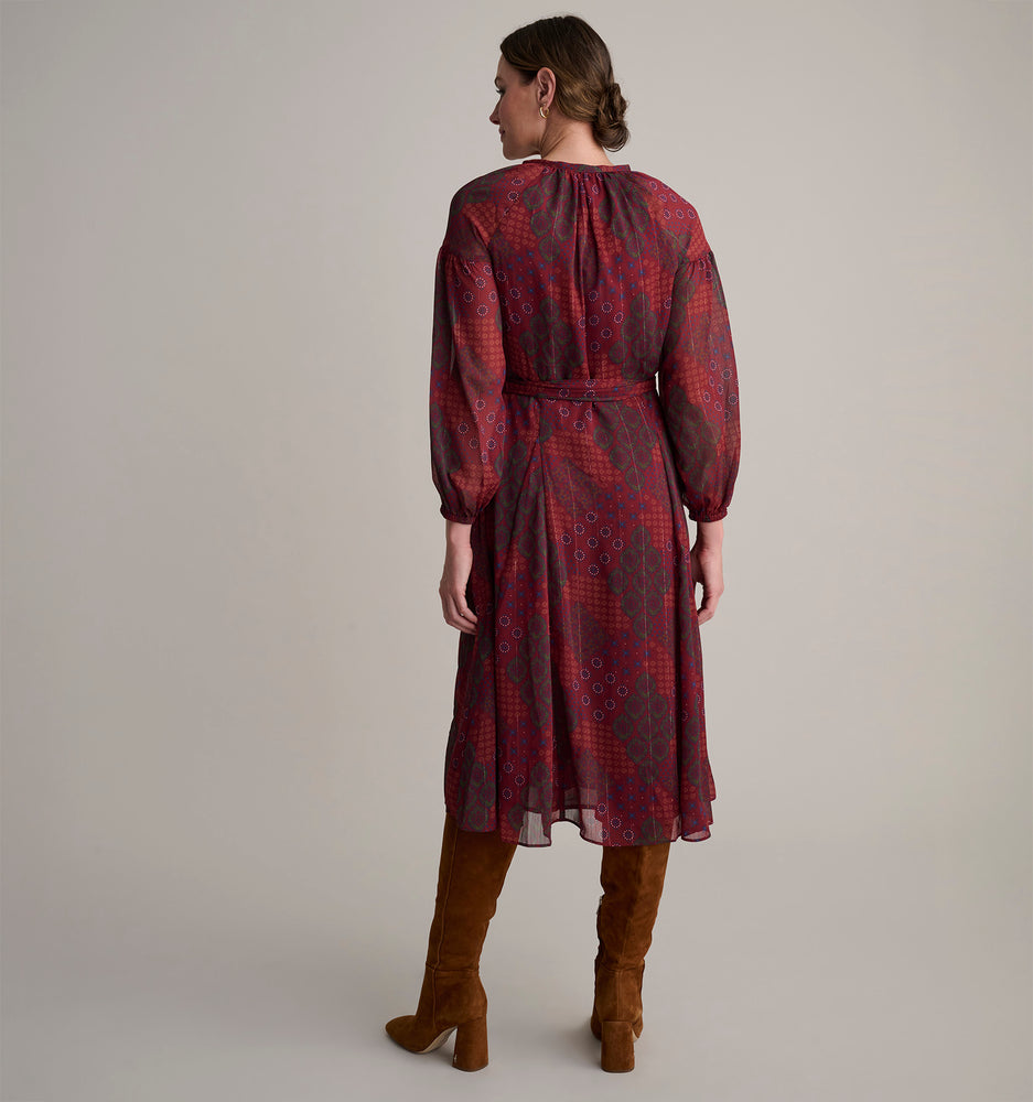 Model is wearing UNTUCKit Carly printed red dress. 
