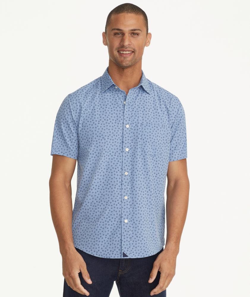 Model is wearing UNTUCKit Wrinkle-Free Performance Short-Sleeve Carnelian Shirt in Flower Print.