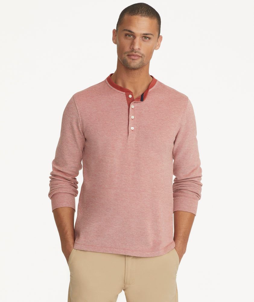 Model is wering UNTUCKit Cascudo Long Sleeve Pique Henley in Chili Oil.