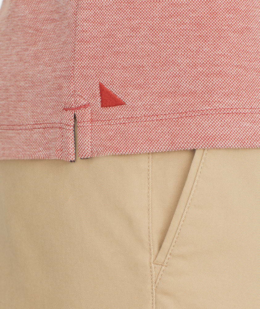 Model is wering UNTUCKit Cascudo Long Sleeve Pique Henley in Chili Oil.