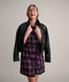 Model is wearing UNTUCKit Cassie dress in purple plaid. 