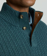 Model is wearing UNTUCKit Cable-Knit Button Neck Sweater in forest. 