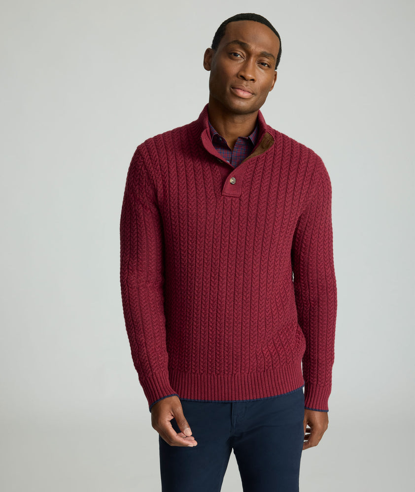 Model is wearing UNTUCKit Cable-Knit Button Neck Sweater in red. 