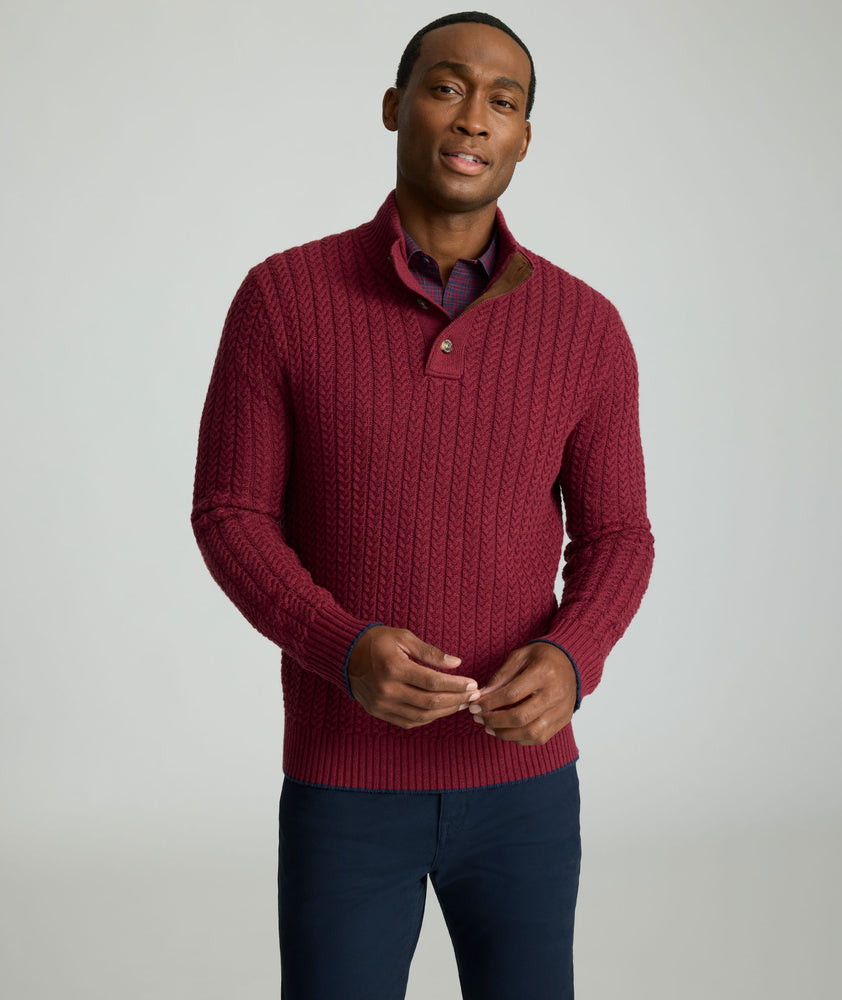 Model is wearing UNTUCKit Cable-Knit Button Neck Sweater in red. 