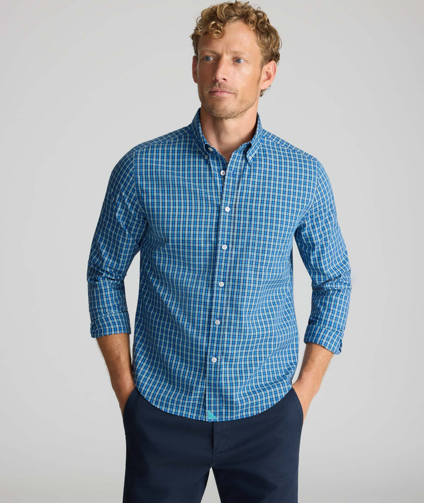 Model is wearing UNTUCKit Wrinkle-Free Castro Shirt in navy.