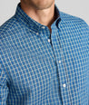 Model is wearing UNTUCKit Wrinkle-Free Castro Shirt in navy.