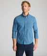Model is wearing UNTUCKit Wrinkle-Free Castro Shirt in navy.