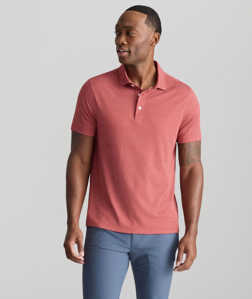 Model is wearing UNTUCKit Wrinkle-Free Damaschino Polo in Red Medallion Print.