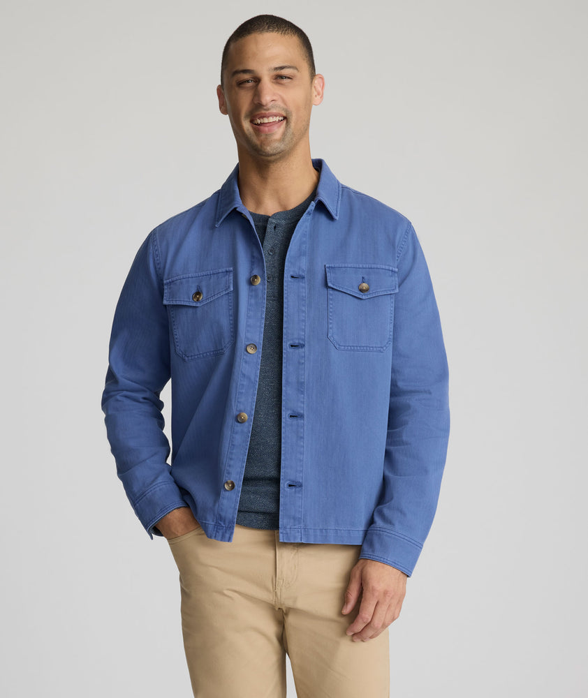 Model is wearing UNTUCKit Chadwick over shirt in Gray Blue. 