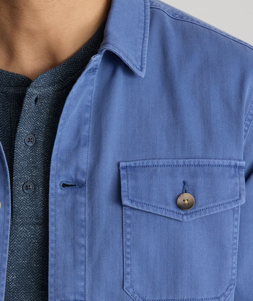 Model is wearing UNTUCKit Chadwick over shirt in Gray Blue. 