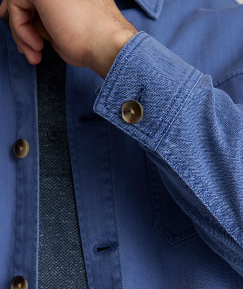 Model is wearing UNTUCKit Chadwick over shirt in Gray Blue. 