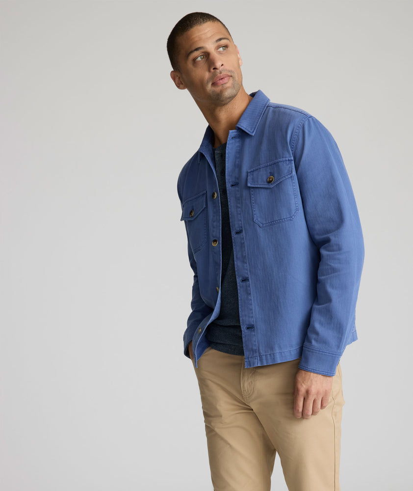 Model is wearing UNTUCKit Chadwick over shirt in Gray Blue. 