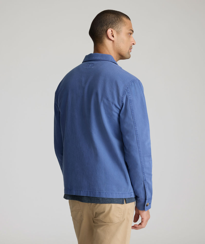 Model is wearing UNTUCKit Chadwick over shirt in Gray Blue. 