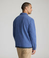 Model is wearing UNTUCKit Chadwick over shirt in Gray Blue. 
