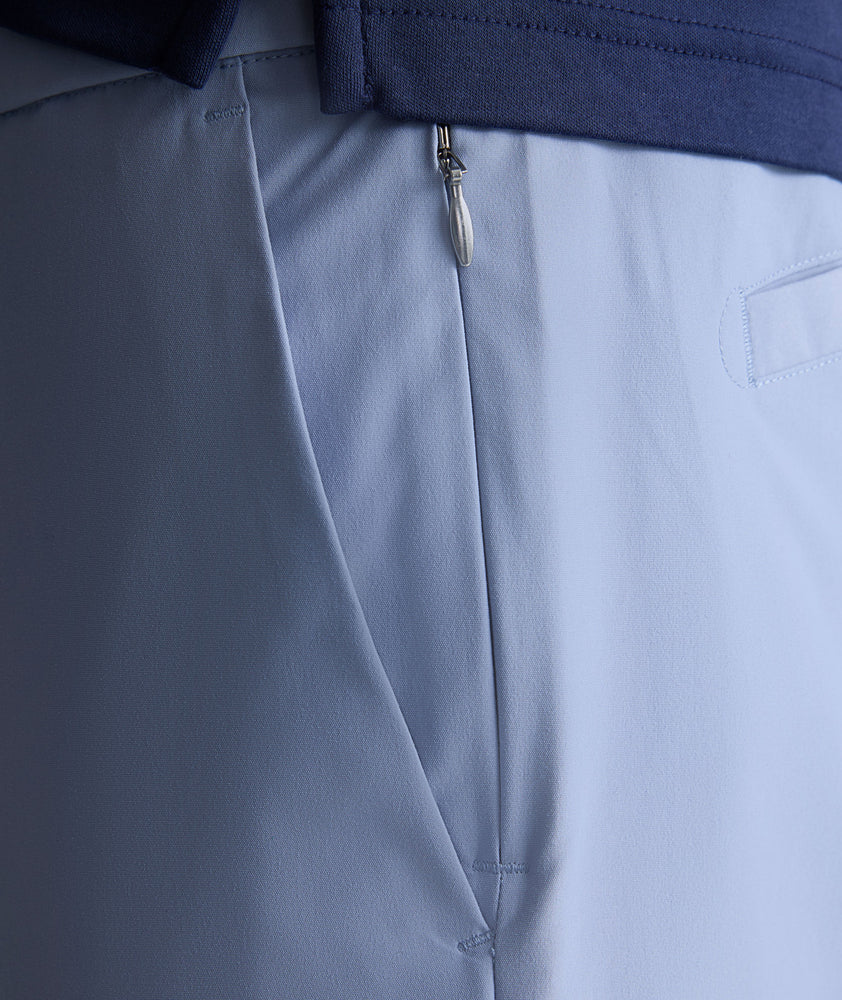 Model is wearing UNTUCKit traveler pants in stone wash.