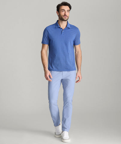 Model is wearing UNTUCKit traveler pants in stone wash.