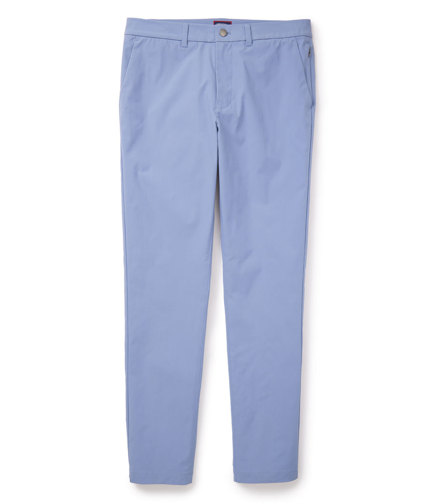 Model is wearing UNTUCKit traveler pants in stone wash.