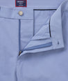 Model is wearing UNTUCKit traveler pants in stone wash.
