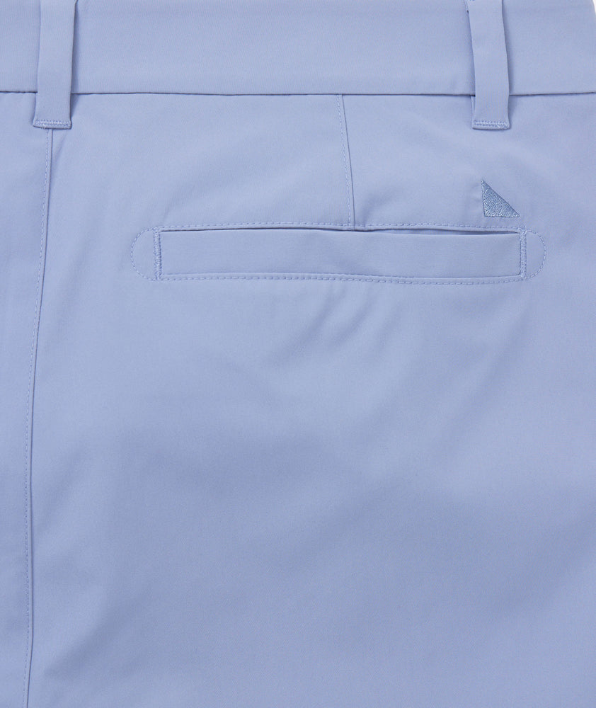 Model is wearing UNTUCKit traveler pants in stone wash.