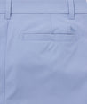 Model is wearing UNTUCKit traveler pants in stone wash.