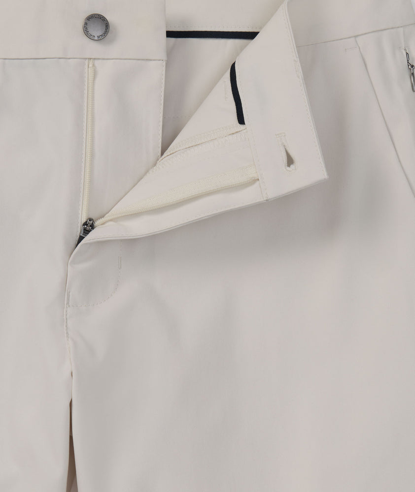 Model is wearing UNTUCKit Traveler Tech Pants in silver birch . 