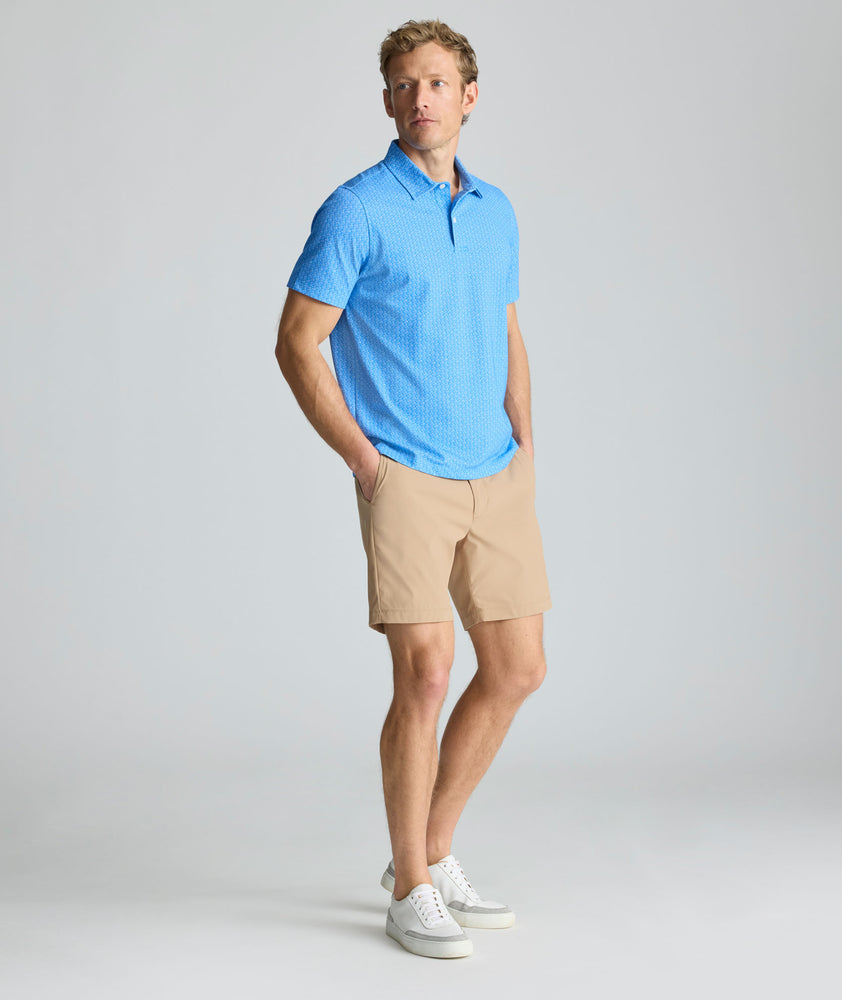 Model is wearing UNTCKit 7" Traveler Tech Shorts in Khaki. 