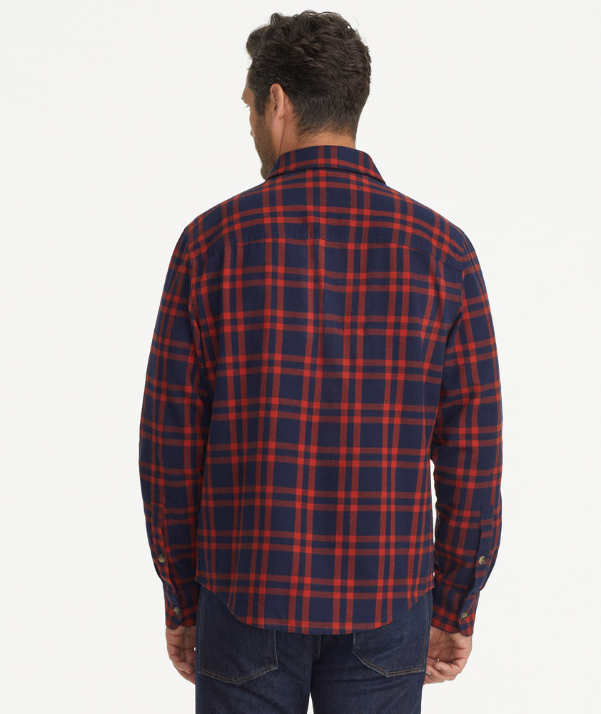Model is wearing UNTUCKit Chaselo Brushed Overshirt in White & Red Check.