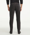 Model is wearing UNTUCKit christow pants in gray.