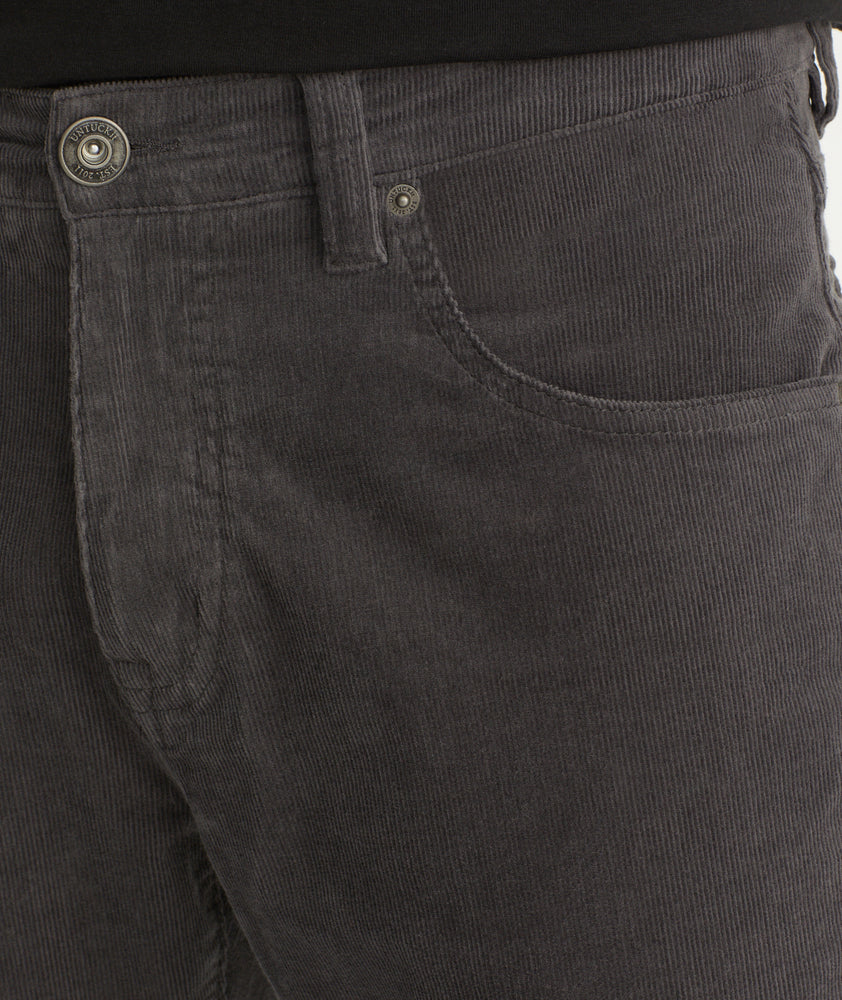 Model is wearing UNTUCKit christow pants in gray.