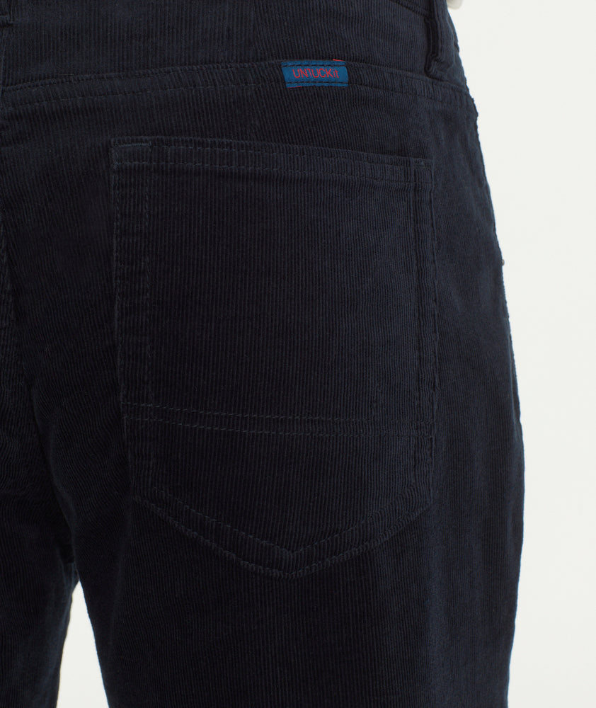 Model is wearing UNTUCKit Christow Cord Pant in Navy