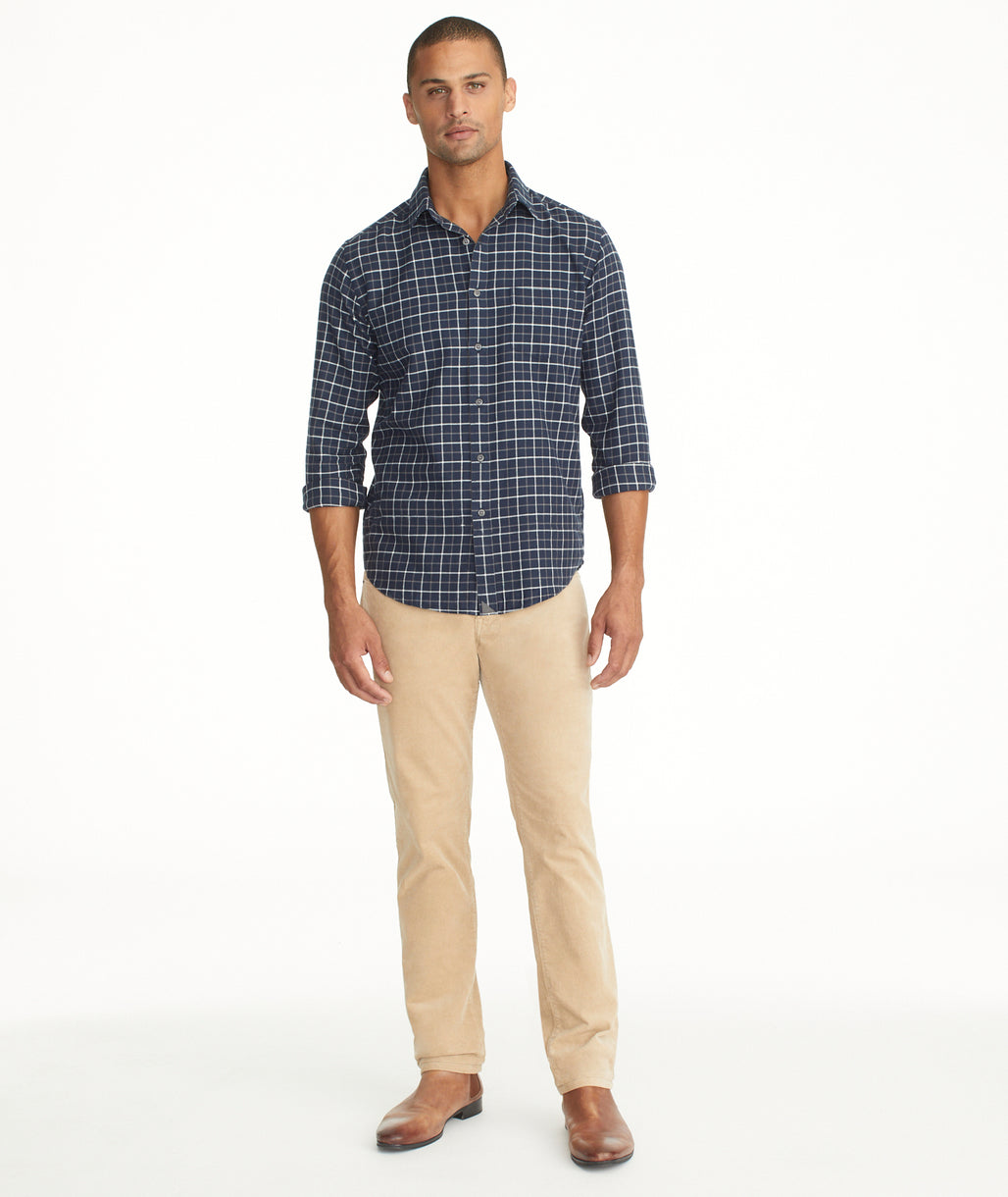 Model is wearing UNTUCKit Christow Cord Pant in Tan.