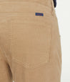 Model is wearing UNTUCKit Christow Cord Pant in Tan.