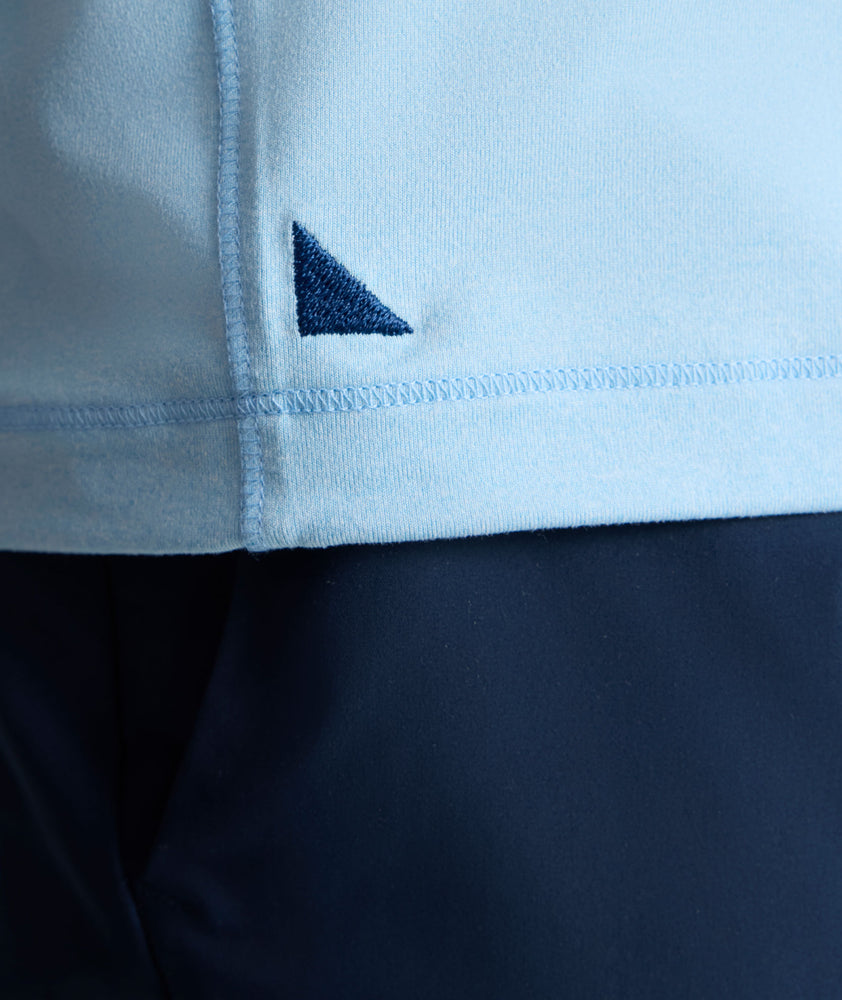 Model is wearing UNTUCKit Performance Tee in light blue. 