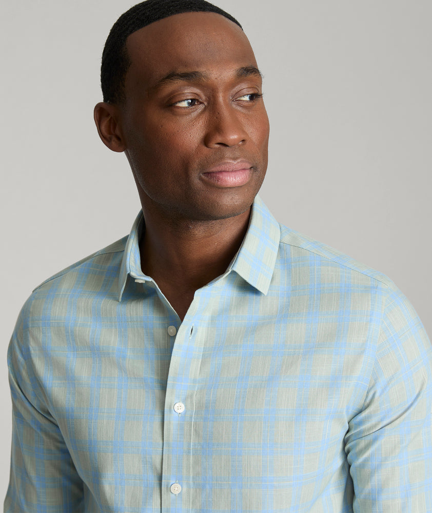 Model is wearing UNTUCKit Clark wrinkle-free shirt in green. 