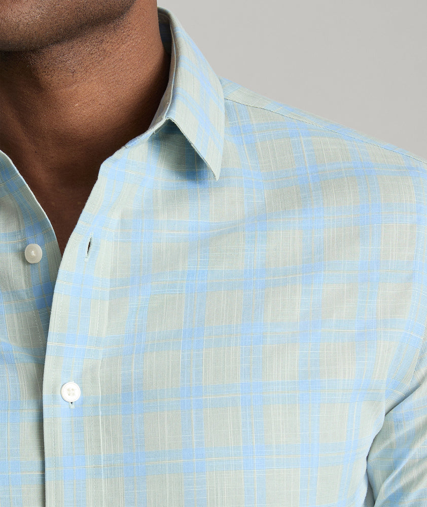 Model is wearing UNTUCKit Clark wrinkle-free shirt in green. 