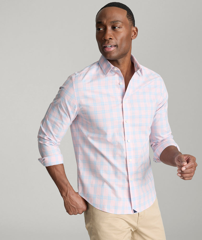 Model is wearing UNTUCKit Clark shirt in light pink check. 