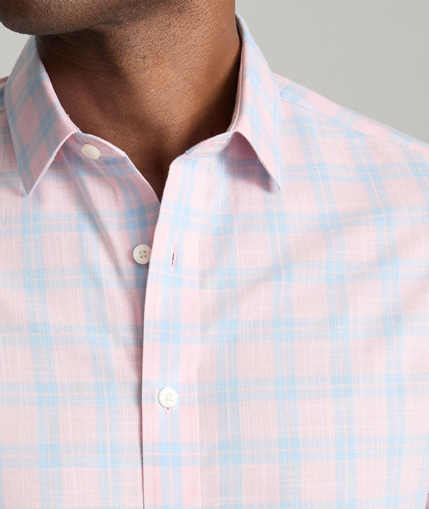 Model is wearing UNTUCKit Clark shirt in light pink check. 