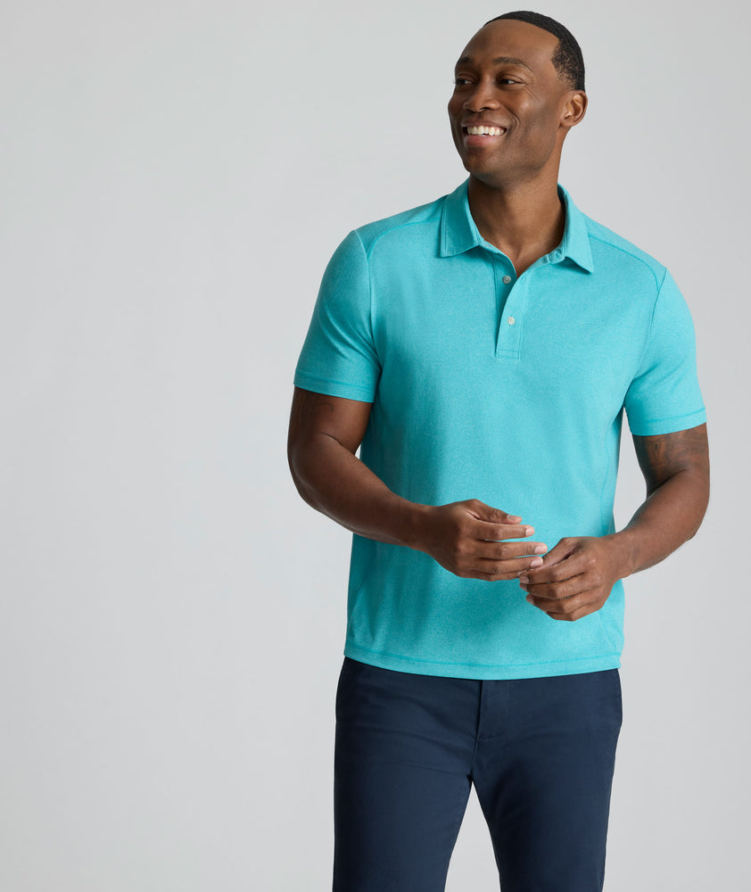 Model is wearing UNTUCKit Performance Polo in teal. 