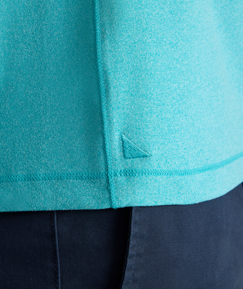 Model is wearing UNTUCKit Performance Polo in teal. 